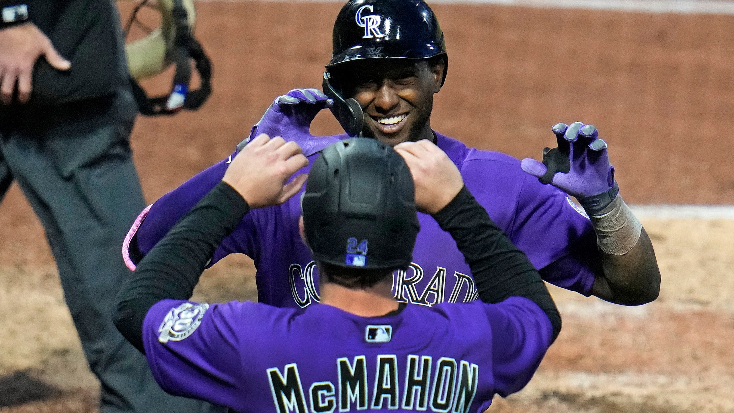 Colorado Rockies' Jurickson Profar, rear, celebrates with Ryan McMahon as he returns to the dugout