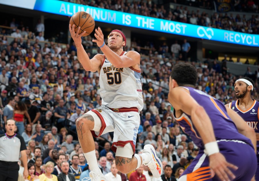 Denver Nuggets forward Aaron Gordon, left, drives the lane as Phoenix Suns guard Devin Booker defends