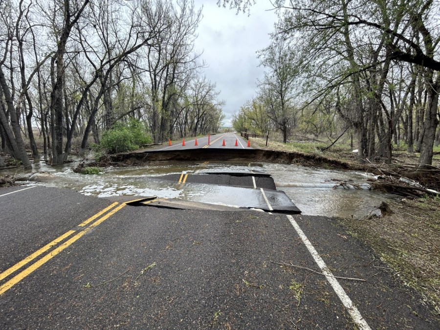 A road is broken and water fills its place.