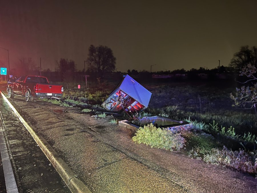 A power box is off its foundation on the side of the road