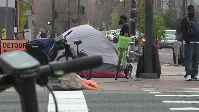 A tent on the sidewalk in Downtown Denver