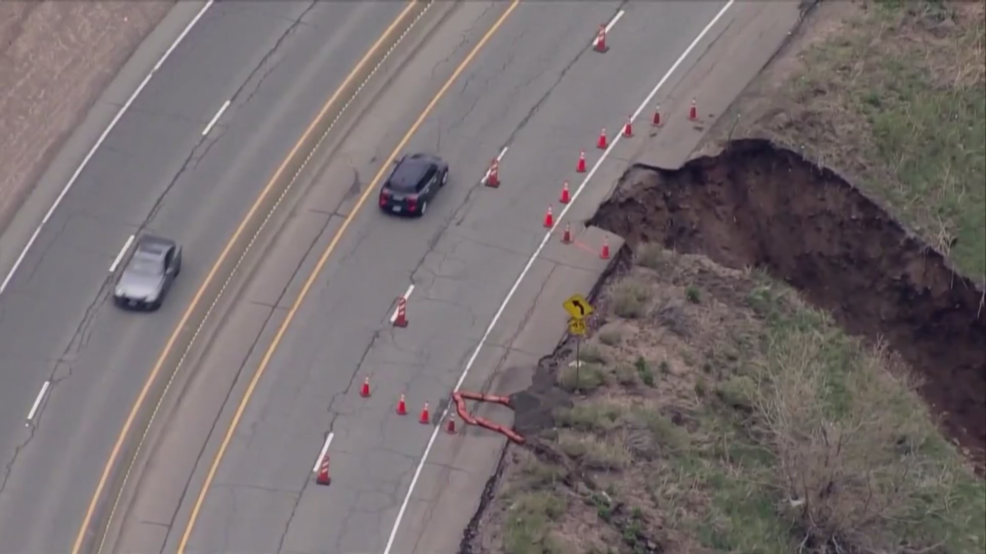 Aerial image of cars traveling on a highway with part of it eroded along a downhill