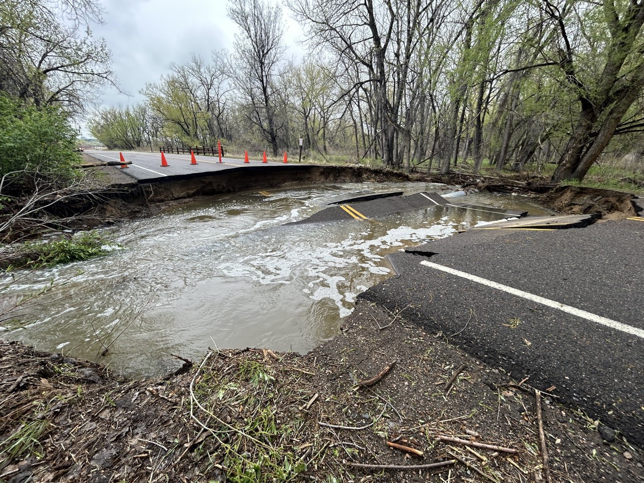 A road is broken and water fills its place.