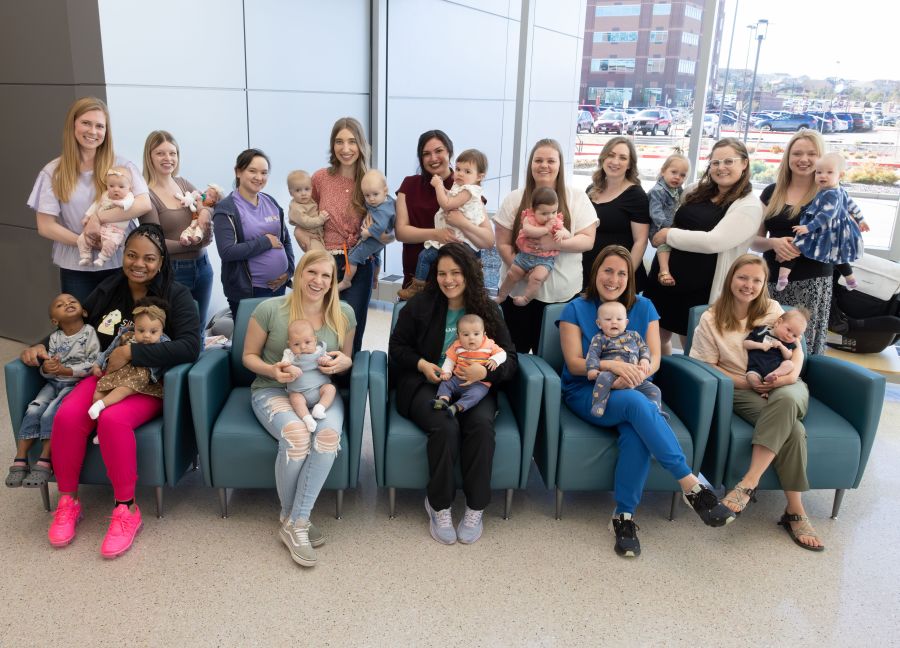 22 nurses and 14 babies gathered for a group photo.